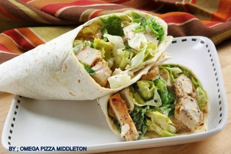 Grilled chicken Caesar wraps with fresh romaine lettuce and creamy dressing in flour tortillas.